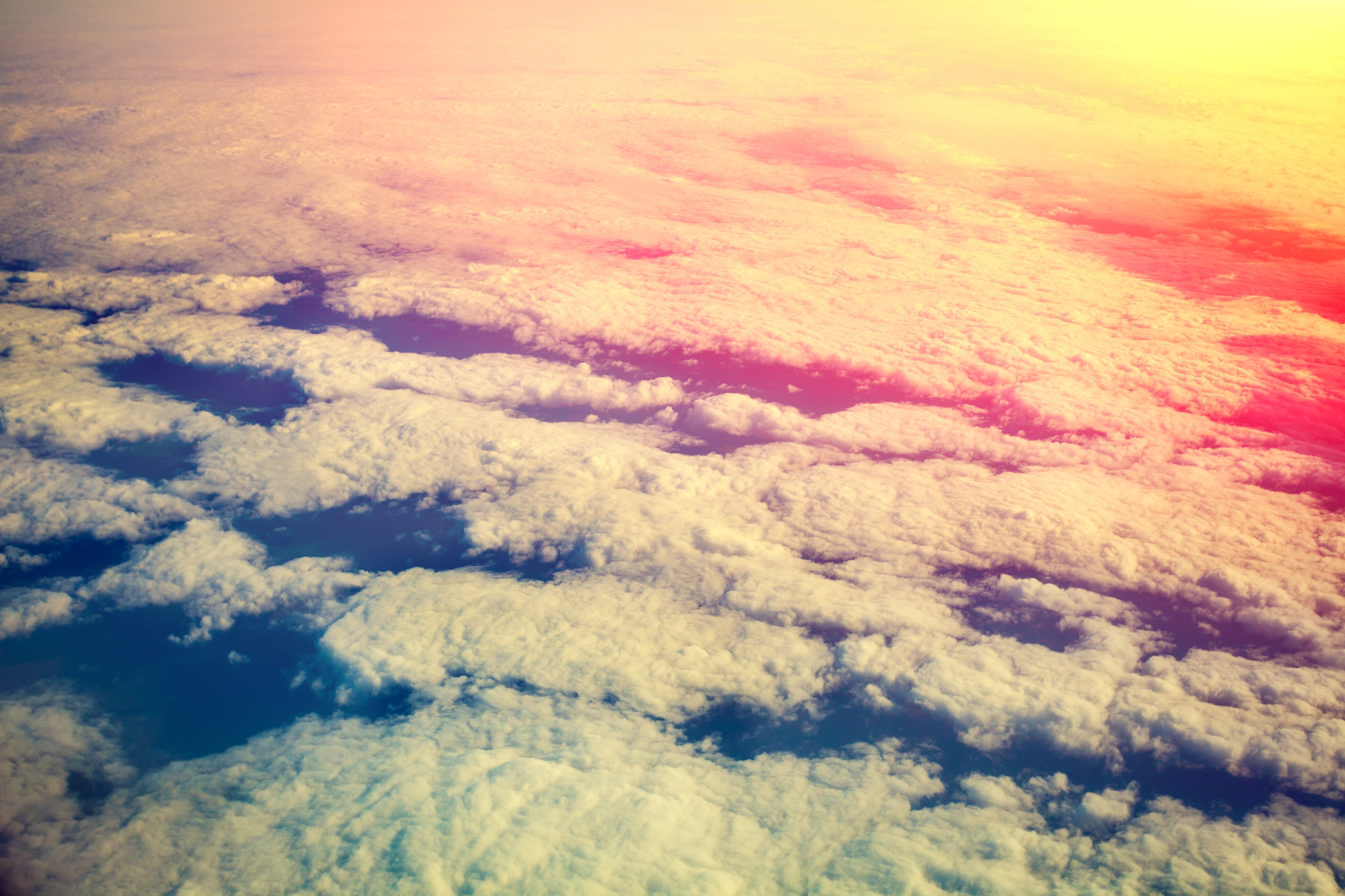 Cloudy sky at sunrise. View from airplane window